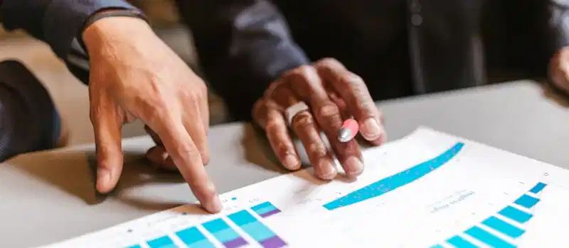 Business professionals analyzing charts and graphs during a meeting.