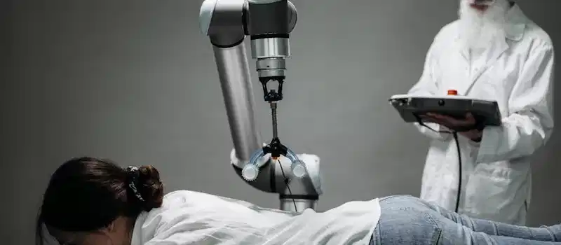 A woman receives a robotic massage as a scientist monitors, showcasing modern technology.