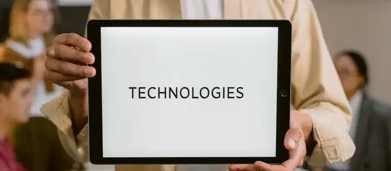 Business professionals discussing technologies, shown on a tablet in an office setting.