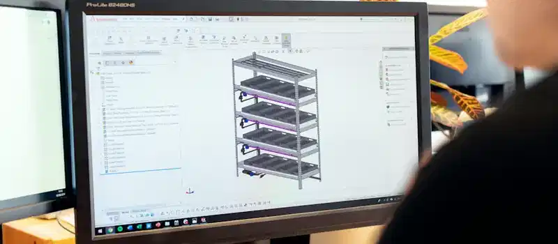 Close-up of an engineer using CAD software for vertical farm design on a desktop computer.