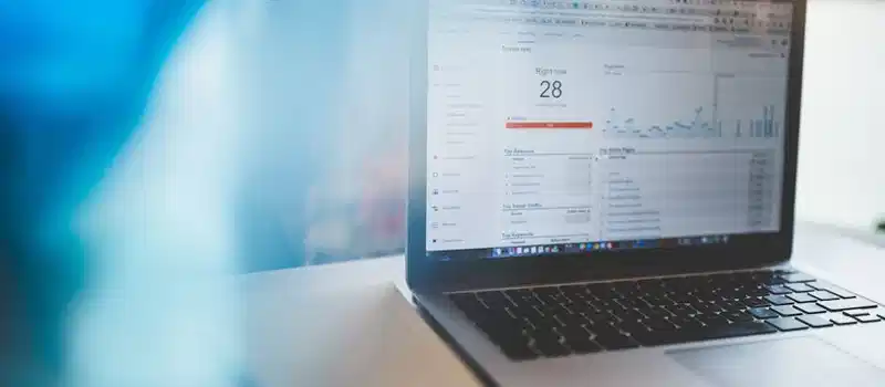 Laptop displaying Google Analytics in a modern workspace, highlighting digital analytics and technology.