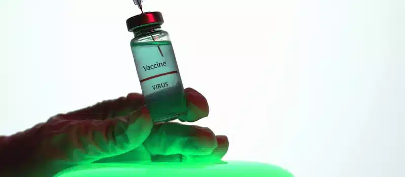 Close-up shot of a virus vaccine vial labeled with a syringe, highlighting medical research.