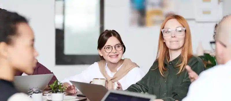 A group of diverse professionals collaborating in a modern office setting.