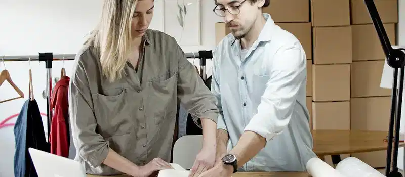 Team members packing orders in an online store's workspace, exemplifying efficient teamwork.