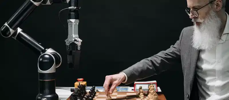 A bearded man strategically moves chess pieces while an AI robot arm assists in a futuristic game.