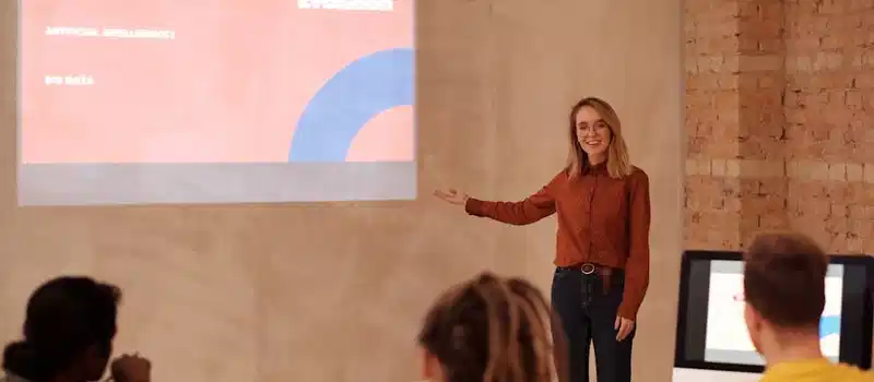 Young woman presenting on digital evolution concepts like AI and big data in a seminar.