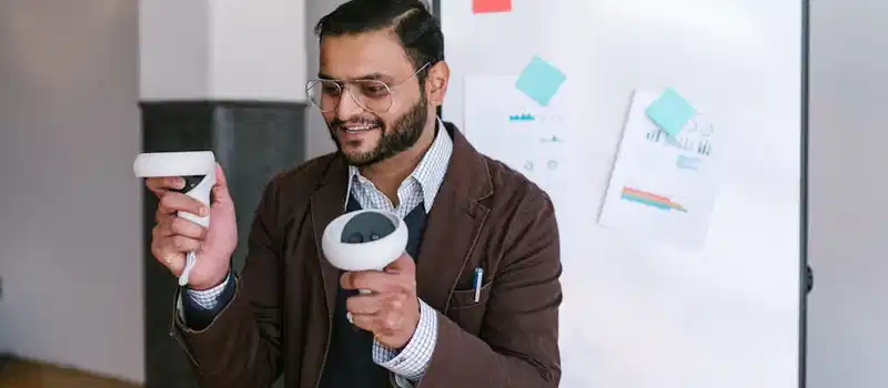 A business professional demonstrating virtual reality controllers during a presentation.