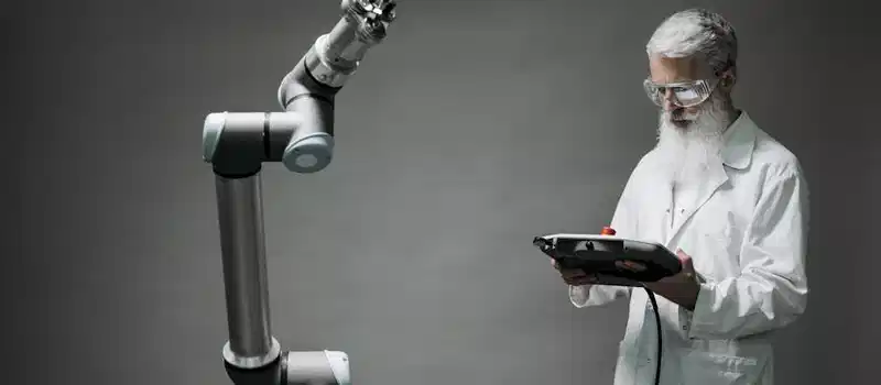 A scientist in a lab coat operates a high-tech robotic arm in a laboratory setting.