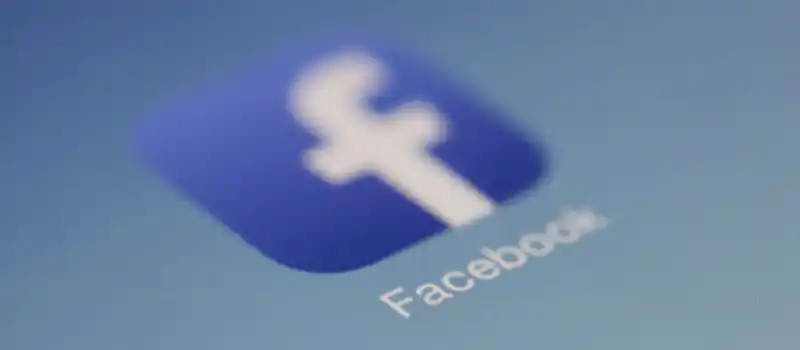Close-up view of the Facebook app logo on a digital screen with blurred background.