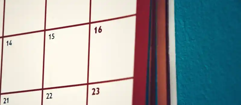 A minimalist calendar hanging on a colorful wall, perfect for planning and organization.