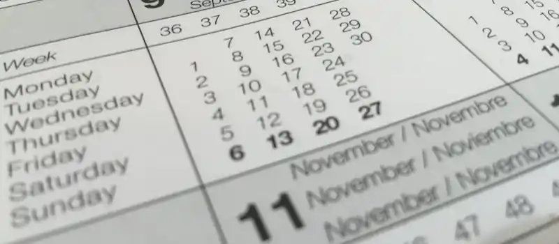 Detailed close-up of a calendar displaying months in several languages.