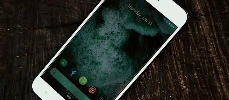 A close-up shot of a smartphone displaying social media app icons, showcasing modern connectivity.