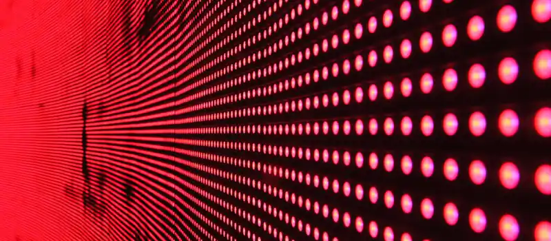 Vibrant abstract pattern of illuminated red LED lights forming a dynamic design.