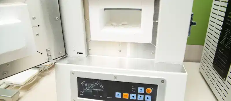 Close-up of a modern dental laboratory apparatus with open door, showcasing advanced technology.