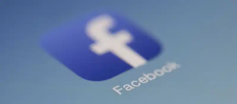 Close-up view of the Facebook app logo on a digital screen with blurred background.