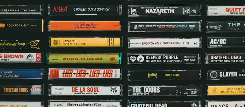 A nostalgic display of vintage cassette tapes featuring iconic bands and albums from the past.