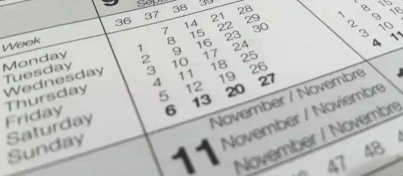 Detailed close-up of a calendar displaying months in several languages.