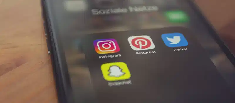 Smartphone displaying popular social media apps like Instagram, Pinterest, Twitter, and Snapchat.