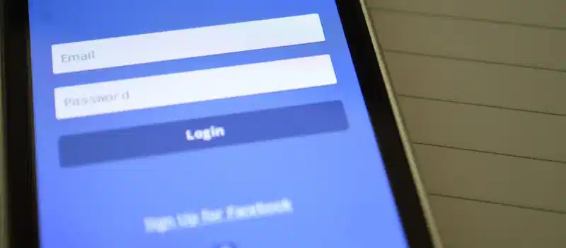 Mobile phone with Facebook login screen, highlighting digital connectivity and social media use.