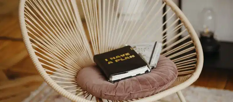 Comfortable wicker chair with planner, ideal for a cozy home office setup.