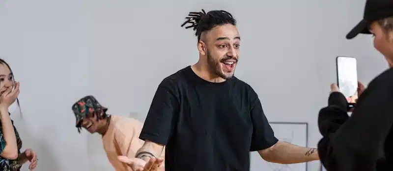 Young adults recording an energetic video with smartphones, expressing creativity and teamwork.