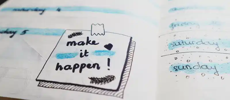 Close-up view of a planner page with motivational text and colorful designs.