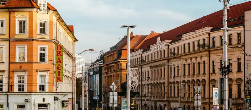 Lively urban scene depicting pedestrians and historical architecture in Bratislava.