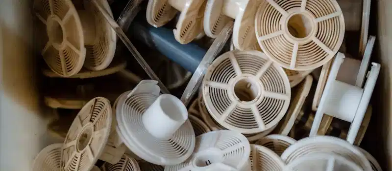 An abstract still life of multiple white plastic reels in a close-up view, offering a unique perspective.