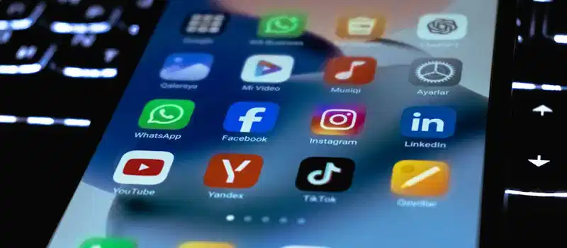 Close-up of a smartphone screen showing popular social media and utility app icons.
