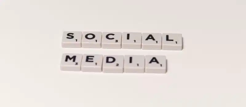 Scrabble tiles spelling 'social media' on a white background, representing digital communication concepts.